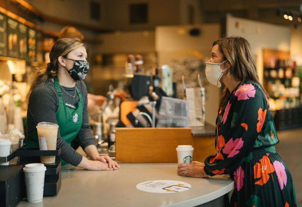 Michelle Burns with barista in Starbucks store